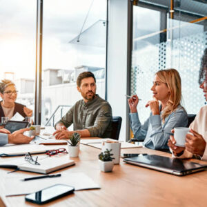 Business concept. Multinational professionals business people discussing daily topics by table in modern office. Business meeting.